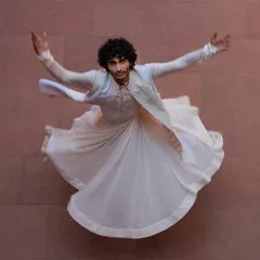 A dynamic shot of a groom's angrakha-style kurta, captured in motion. This look, inspired by Sufi dancers, is for the groom who wants something artistic and unique.