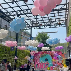 To make the venue feel even more like Wonderland, I hung balloon clouds from the ceiling, creating a dreamy, surreal sky above the main party area.