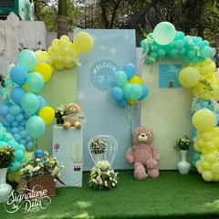 The main backdrop for the baby shower, with balloon arches in pastel shades, teddy bears, and floral arrangements creating a sweet and charming photo spot.