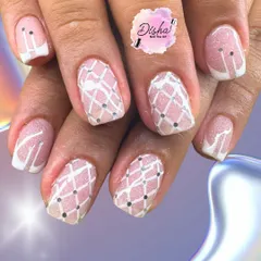 It's all in the details. This design features a delicate lattice pattern with tiny silver dots, all hand-painted over a soft pink glitter base for a chic and precise finish.