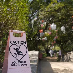 We love adding witty details. This custom "Caution: You Might Fall In Love" sign added a touch of humor and personality to the entrance of the Valentine's event.