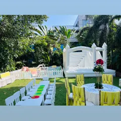 We can transform any garden into a complete kids' fun zone. This setup features our popular all-white bouncy castle, a safe soft play area, and clean, white child-sized tables and chairs, perfect for a stylish and fun-filled birthday party.