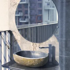 An example of integrating raw, natural elements into an urban setting. This hand carved stone sink on a balcony provides a functional feature while adding an earthy, organic texture that contrasts with the city view reflected in the mirror.