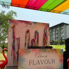 A closer look at the custom-branded DJ console and backdrop for the Holi 2024 event.