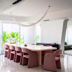 Color and form are central to our storytelling. For the dining area in Apartment 56, we custom-designed these volumetric, velvet-upholstered chairs and a matching pink table to introduce warmth and bold character into an otherwise minimal, open-plan space.