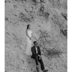 A minimalist black and white portrait set against the rocky textures of the Dubai landscape. The simple composition and timeless editing style put the focus entirely on the couple's presence and connection.