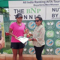 Reva Rana, an unseeded player, proudly accepts her trophy after reaching her first AITA CS National U-14 finals. Her journey to the final included defeating the second-seeded player.