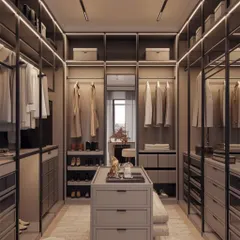 This walk-in closet is all about organization and style. It features an open-concept wardrobe system with designated spaces for clothes, shoes, and accessories, centered around a functional island with drawer storage.