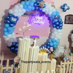 A Boss Baby ring decoration with a neon sign, perfect for a modern and fun first birthday party.