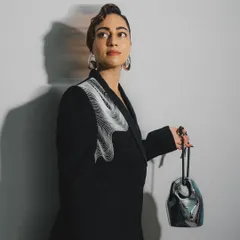The full view of this slick, sculpted wave hairstyle. It’s a testament to how hair can be a piece of art, perfectly matching the avant-garde feel of the outfit.