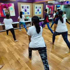 Participants practice basic stances and movements during a corporate workshop. These foundational skills are crucial for maintaining balance and generating power for blocks and strikes.