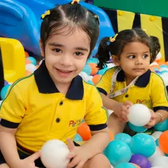 A happy student from Petals Pre School enjoying our vibrant ball pit. We ensure a clean and safe environment for all our little guests during their kids group picnic.