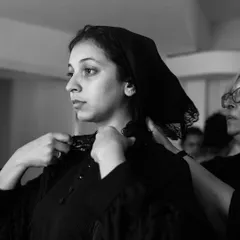 An actor gets her veil adjusted during costume fittings. The details in costuming are crucial for building the world of the play.