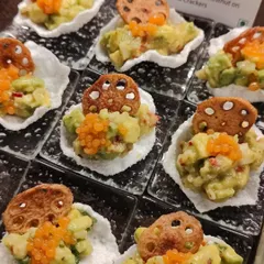 A burst of texture and flavour. This appetizer features kaffir lime avocado and water chestnut on a crispy sabudana cracker, topped with tobiko. It's one of our signature fusion bites that always gets people talking.