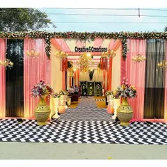 For the modern couple, I created this chic and stylish wedding entrance. The bold black and white chevron floor, paired with soft pink draping and elegant chandeliers, offers a contemporary twist on classic wedding decor.