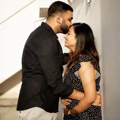 A tender forehead kiss is a simple yet powerful way to show affection. This candid moment from a pregnancy announcement shoot is full of warmth and happiness, perfectly capturing the couple's love.