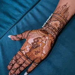 A modern love story captured in henna for an engagement. This design features a romantic couple portrait set against a city skyline, with their names beautifully written on the forearm.