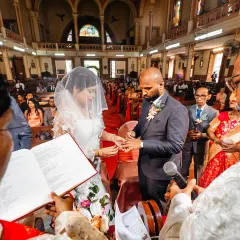 The exchanging of the rings, a pivotal moment in any wedding. I took a risk to get this unique over-the-shoulder perspective from behind the Bishop.
