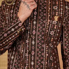 Royalty in every detail. This close-up of a brown sherwani highlights the rich texture and intricate patterns, a testament to the craftsmanship I pour into each piece.