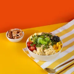 The Pesto Piccolo bowl in all its glory. It features durum wheat pasta, crisp lettuce, cherry tomatoes, and protein-rich lima beans for a perfectly balanced and satisfying meal.