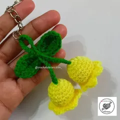 This delicate Lily of the Valley keychain features two yellow bell-shaped flowers and a bright green leaf. It's a unique floral accessory, handmade with attention to detail.