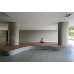 An open, ground-floor plinth at the School of Arts and Sciences at Ahmedabad University serves as a versatile social space. The minimalist design, with its robust concrete columns and integrated seating, provides a place for students to gather, study, and relax.