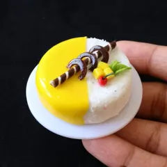 A close-up of a miniature mango cake, a perfect example of the hyper-realistic cakes you can create in my class.
