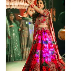 The bride owns the dance floor in her stunning illuminated lehenga during her Sangeet performance. A perfect shot of energy and celebration.