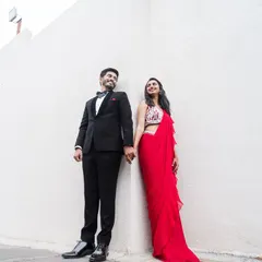A stylish couple portrait against a clean, modern backdrop. Perfect for capturing the elegance of a reception or cocktail party.