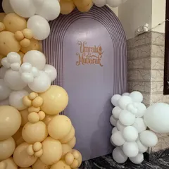This image focuses on the custom 'Umrah Mubarak' backdrop, framed by the beautiful balloon garland. I can create custom backdrops for any religious or cultural event.