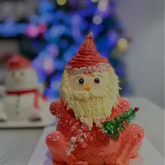Ho ho ho. Here is my detailed Santa Claus cake, crafted with red and white frosting and a fluffy buttercream beard. It's a cheerful creation that brings the magic of Christmas to life.