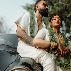 A stylish portrait of a couple in traditional South Indian attire, posing with a vintage car. This shot shows our ability to blend cultural elegance with a modern, cool aesthetic.