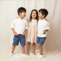 The three siblings share a secret, laughing and looking at each other. It’s these unposed, interactive moments that tell the best stories about sibling dynamics.