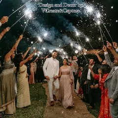The couple makes their grand entrance through a sparkler tunnel, a perfect way to kick off a night of celebration.