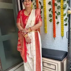 A client ready for Sindoor Khela in a classic white and red Bengali saree. The beauty of this drape lies in its simplicity and the way the pallu is traditionally styled.