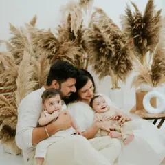 A candid moment of a family of four enjoying their time together in the studio. The focus is on their natural interactions and the love that fills the space.