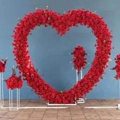 A large, heart-shaped floral arch made entirely of red roses. This makes a stunning photo backdrop for a Valentine's Day corporate event or any celebration of love and appreciation.