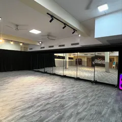 A view of our studio's full wall of mirrors. This essential feature helps dancers refine their technique, check their alignment, and perfect their movements in a professional setting.