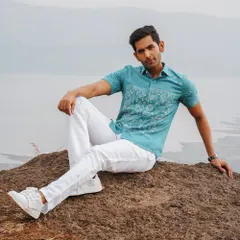 A modern take on style, this teal shirt features hand-embroidered panther motifs on sustainable Kala cotton from Kutch. It's a perfect example of nature-inspired fashion that is both bold and refined.