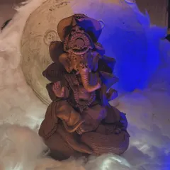 A beautifully sculpted Ganesha idol, created during one of our workshops. The dramatic lighting highlights the fine details and the natural texture of the terracotta clay.