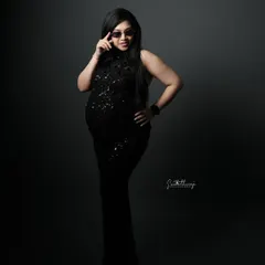 A glamorous and bold portrait in a black sequined gown. The dramatic lighting and confident pose with sunglasses create a high-fashion, movie-star look.