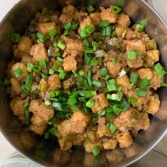A bowl of my popular Babycorn Manchurian, crispy and tossed in a savory sauce.
