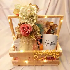 Celebrate the happy couple with this 'Congratulations' hamper. Packed in a rustic wooden crate, it features personalized mugs and other treats, all illuminated by our signature fairy lights.