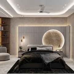 This bedroom design for a project in Meera Bagh features a serene, beige-themed decor. The centerpiece is the custom, moon-shaped marble carving behind the bed, which adds a touch of artistry and serves as a unique focal point for this tranquil retreat.