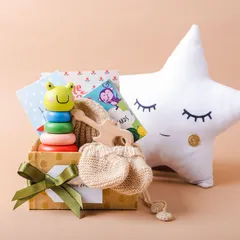 Our "Hello Little One" hamper is the perfect gift for new parents. It's filled with adorable and useful items like a stacking toy, milestone cards, and hand-knitted mittens.