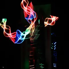 A long-exposure shot capturing the beautiful trails of light created by our Pixel Poi artist, blending multiple colors into a flowing ribbon of light.