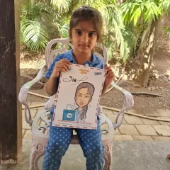 A young girl proudly holding up her personalized caricature. These make wonderful and unique gifts for children.