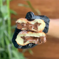 A cross-section of our Nutella Berliner, oozing with rich chocolate hazelnut spread. This one is a favourite for kids and adults alike.