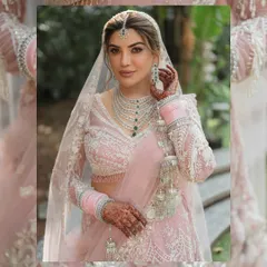 A stunning close-up of the Sikh bride, highlighting her intricate jewelry, soft makeup, and the delicate details of her pastel lehenga.