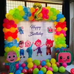 A vibrant and fun Cocomelon theme party for a 2nd birthday. This setup includes a colorful balloon arch, a custom backdrop with all the favorite characters, and a floor full of balloons for the kids to play in.